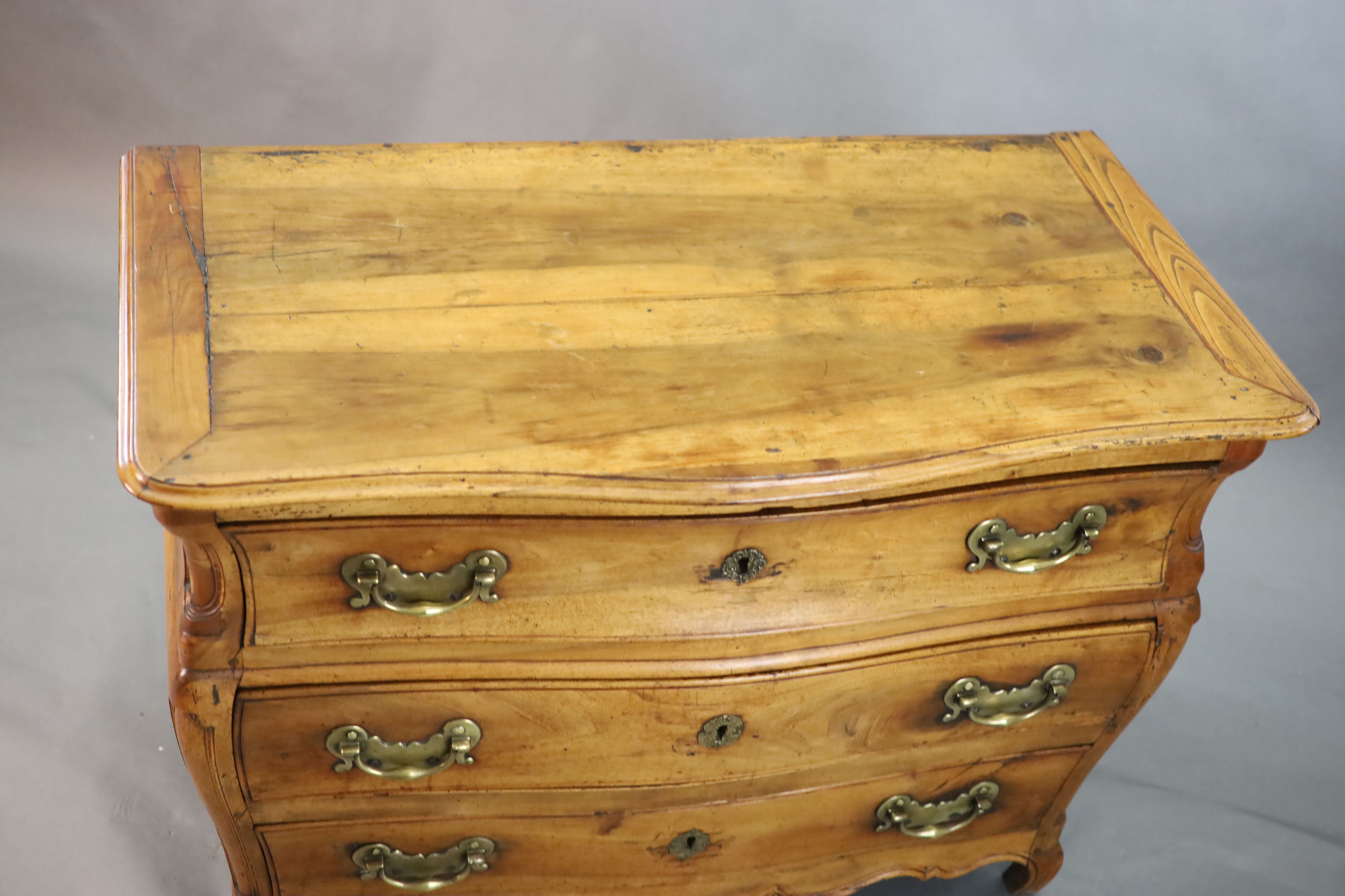 A 19th century Continental walnut serpentine commode, W.3ft 10in. D.2ft 1in. H.2ft 8in.